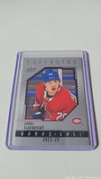 Photo of Juraj Slafkovsky rookie hockey card from 2022-23 Panini Superstar Honroll series in protective sleeve.