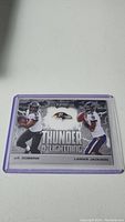 Photo of a Playoff Thunder & Lightning football card featuring Lamar Jackson and J.K. Dobbins.