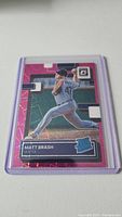 Photo of Matt Brash rookie baseball card in a clear plastic protective holder, displaying player name, team Seattle, and Rated Rookie logo.
