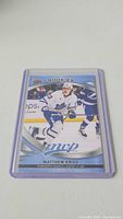 Photo of Matthew Knies rookie hockey card in protective case, showing front image of player in white Toronto Maple Leafs jersey.