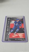 Photo of a Mitch Marner rookie hockey card from Upper Deck SP Authentic Silver Skates series in a protective sleeve.