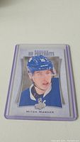 Close-up image of the Mitch Marner rookie hockey card in a clear protective case.