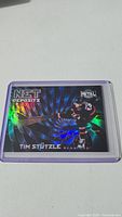 Photo of Tim Stützle's rookie hockey card featuring Net Deposits design from Metal Universe series, in a protective sleeve.