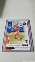 Front of Trevor Lawrence rookie football card in protective purple sleeve.