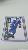 William Nylander rookie hockey card in a protective sleeve, showing player in blue uniform and card branding.