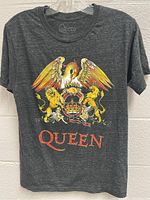 Front of grey Queen band T-shirt showing detailed crest logo with phoenix, lions, crown and 'QUEEN' text in red.