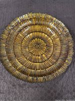 Top view of round glass bowl with concentric ripple design in gold