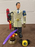 Full body photo of Inspector Gadget figure with visible mechanical arms and accessories including a hat with umbrella and a watch