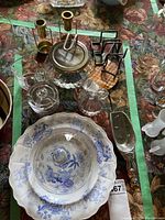 Assorted kitchen entertaining items including candle holders, glassware, cream and sugar, and decorative plates.