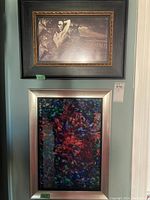 Both pictures hanging on the wall, showing the black and white framed print above and the colorful abstract framed artwork below.