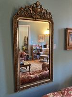Full view of gilded framed mirror mounted on wall
