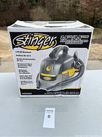 Closed box of brand new Stinger 2.5 gallon wet dry vacuum showing front side with product image and features.