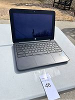 Open HP laptop on table front view showing keyboard and screen.