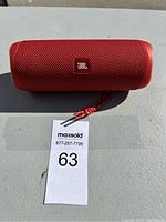 Front view of red JBL portable Bluetooth speaker showing fabric mesh and logo