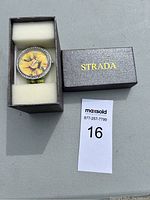 Watch with a floral dial design placed inside original Strada branded box with foam padding.