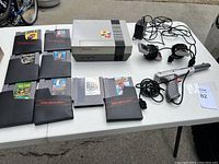 Overhead shot of console, controllers, Zapper, cables and game cartridges on table