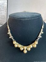 Front view of vintage 1950s pearl and rhinestone choker necklace on black bust display showing pearl and rhinestone detailing.