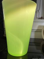 Side view of opaque jadeite glass vase showing color and shape