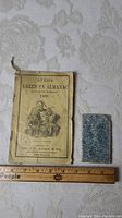 Front covers of two antique almanacs showing scale and condition.