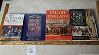Four hardcover books laid flat in a row showing covers: This Sceptred Isle, In Search of the Dark Ages, Stuart England, Four Gothic Kings.