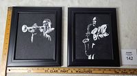 Both framed paintings showing Louis Armstrong and Charles Parker, each approximately 12.5 x 10.5 inches.