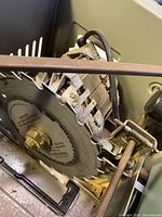 Close-up of the Black & Decker 8 inch circular saw blade on the table saw, showing detail of teeth and part of the motor housing and frame.