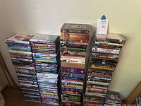 Three tall stacks of DVD and Blu-ray cases