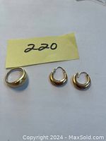 Ring and pair of earrings laid out side by side