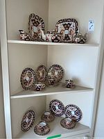 Full shelving display showing two trays, teapot, creamer, sugar bowl, six side plates, six cups and twelve saucers