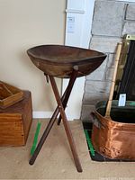 Front and side view of wooden salad bowl on tripod wooden folding stand, showing overall appearance and structure.