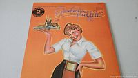 Front of American Graffiti soundtrack album featuring waitress illustration.