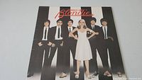 Front cover showing Blondie band members in black and white with red logo.