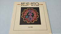 Front cover of the Best Of B.T.O. (So Far) album showing the B.T.O. logo with gear and neon design.