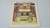 Front cover of the Best Of The Doobies album showing jukebox and diner artwork.