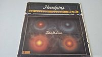 Front cover of the Headpins Turn It Loud vinyl record album showing amplifier design and band name