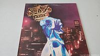 Front cover of Jethro Tull War Child vinyl record album, showing artwork of a glowing figure reaching out against a citynight backdrop.