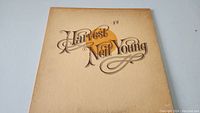 Front of Neil Young Harvest album cover showing art and 'KH' marking