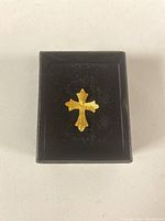 Cross pendant displayed in black box