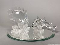 Overview photo of two Swarovski crystal fish figurines on beveled mirror base showing butterfly fish and three South Sea fish.