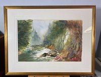 Overall view of the framed watercolour painting showing a misty river scene with cliffs and trees.