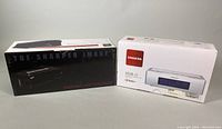 Two boxed items side by side: Sharper Image Portable USB Turntable and Sangean HDR-15 Clock Radio.