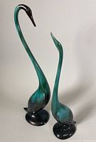 Pair of vintage BMP sculptures including a large crane and smaller swan, side view showing colors and condition