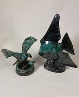 Photo of both angel fish and eagle pottery sculptures showing size and color.
