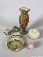 Overview of entire set showing green onyx vase, pair of dice, plate, ashtray, and pink stone on neutral background