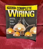 Front cover of Stanley Complete Wiring Guide book showing chandelier image and title.