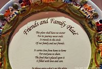 Close-up of the center verse on the ceramic serving platter showing the text of 'Friends and Family Plate' with visible age-related crackling on white background.
