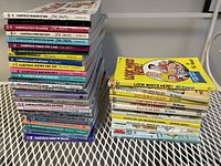 Stack of Garfield comic books by Jim Davis and Bill Keane cartoon books including Look Who's Here and Pasghetti and Meat Buls!