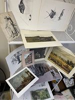 Wide view showing multiple French themed prints and pictures including landscapes, city streets, and sketch studies.