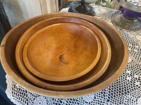 Top view of the set of three nested vintage wooden bowls varying in size from small to large.