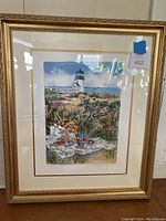 Framed signed limited edition print by Jennifer Winship Mark with lighthouse, bicycle, and picnic scene.